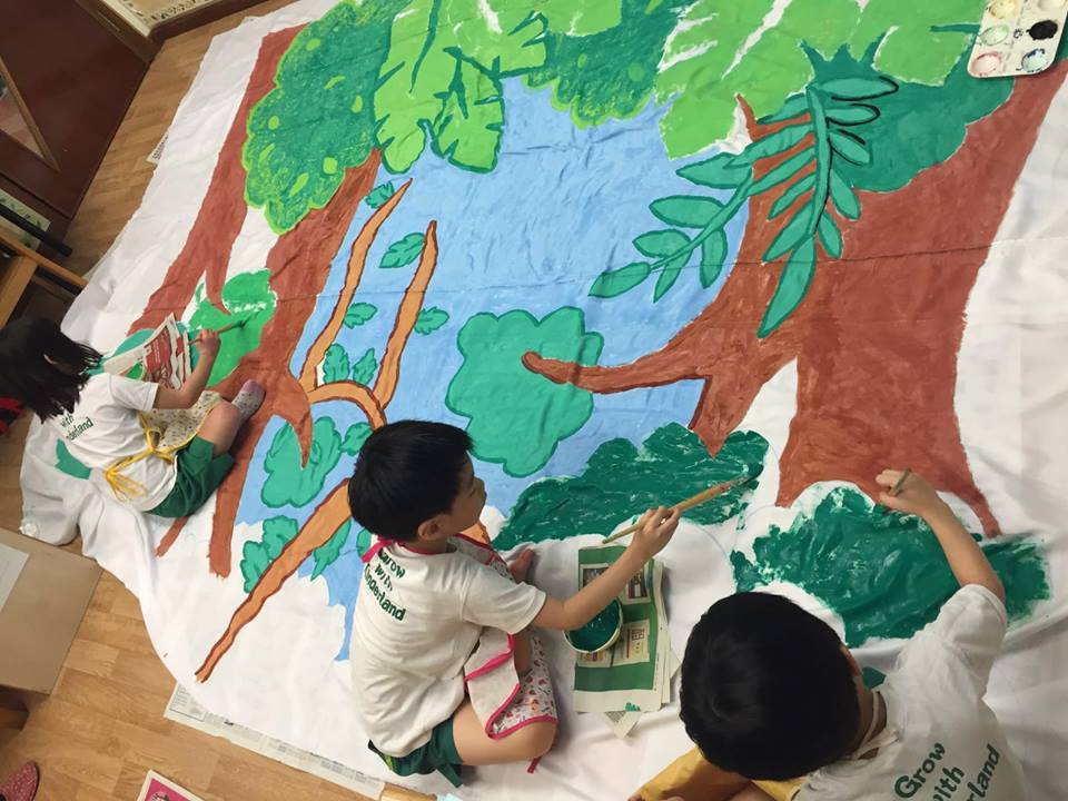 Children painting the backdrop for the photo booth.