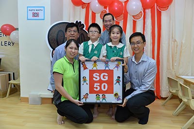 Our children presenting Mr Eugene Leong with a SG50 art piece done by 18 x K2 children